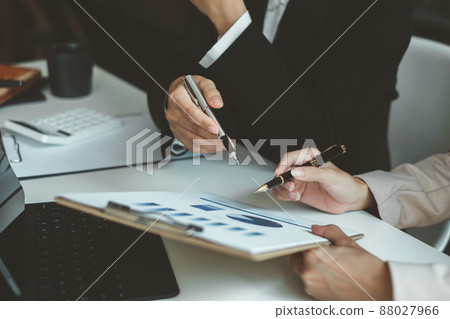 At the office desk, a company team is organizing a successful team building project. Financial concept. At the office desk, a company team is organizing a successful team building project. Financial concept. 88027966