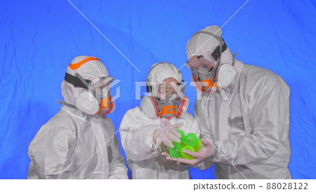 Family of doctors scientists health worker in respirator. Mom dad and daughter portrait, wearing protect medical mask. Coronavirus pandemic covid-19. Family of doctors scientists health worker in respirator. Mom dad and daughter portrait, wearing protect medical mask. Coronavirus pandemic covid-19. 88028122