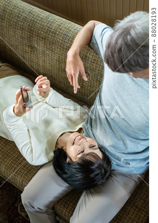 Middle couple relaxing in the living room Middle couple relaxing in the living room 88028193