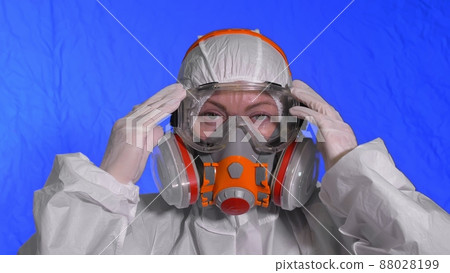 Scientist virologist in respirator. Woman close up look, wearing protective medical mask. Concept health safety N1H1 coronavirus epidemic 2019 nCoV. Scientist virologist in respirator. Woman close up look, wearing protective medical mask. Concept health safety N1H1 coronavirus epidemic 2019 nCoV. 88028199