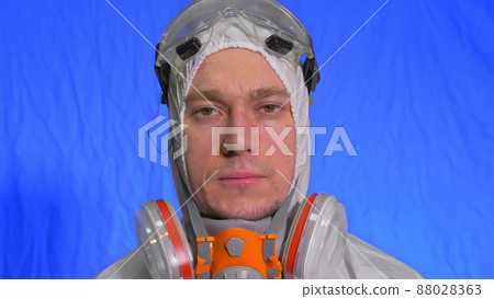Scientist virologist in respirator. Man close up look, wearing protective medical mask. Concept health safety N1H1 coronavirus epidemic 2019 nCoV. Scientist virologist in respirator. Man close up look, wearing protective medical mask. Concept health safety N1H1 coronavirus epidemic 2019 nCoV. 88028363