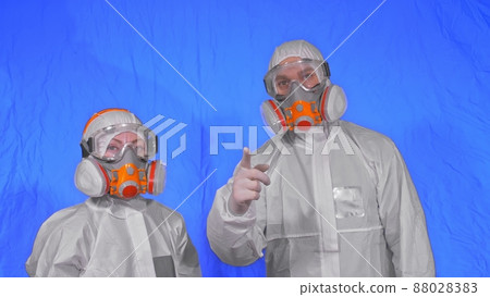Doctor health worker in respirator. Slow motion. People portrait, wearing protect medical antibacterial antiviral aerosol spray paint mask. 88028383