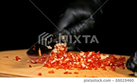 The cook makes salsa. Salsa for burgers on hot Mexican hot recipes. It is prepared from a tomato, red chili peppers, onions, white onions. The cook makes salsa. Salsa for burgers on hot Mexican hot recipes. It is prepared from a tomato, red chili peppers, onions, white onions. 88028460