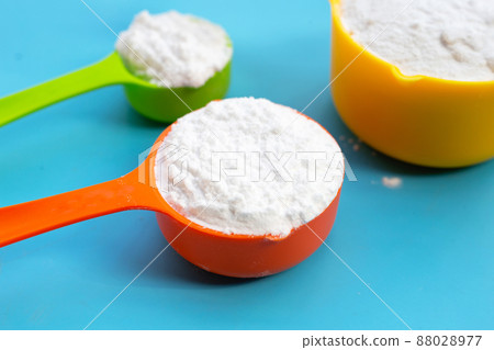 Baking soda on blue background. Baking soda on blue background. 88028977