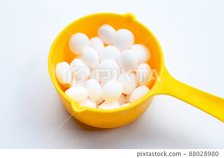Naphthalene mothballs on blue backgrond. 88028980