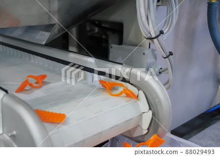 Conveyor belt for removing plastic scraps, pieces, production waste - close up Conveyor belt for removing plastic scraps, pieces, production waste - close up 88029493