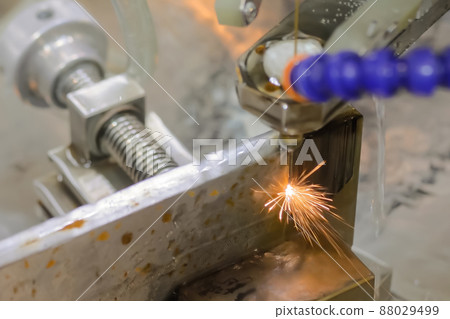 Close up: cnc wire cutting machine working with metal workpiece with sparks 88029499