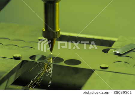 Automatic laser cutting machine working with sheet metal with sparks - close up 88029501
