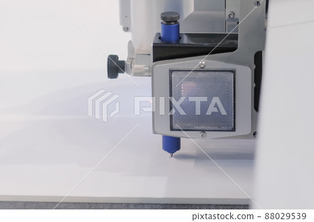 Flatbed cutter, router with drawing pen module writing text on white paper sheet Flatbed cutter, router with drawing pen module writing text on white paper sheet 88029539