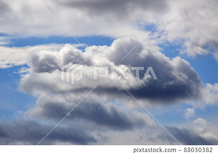 Blue sky with cumulus clouds. The clouds are gray, blue and white. Backgrounds. Blue sky with cumulus clouds. The clouds are gray, blue and white. Backgrounds. 88030382