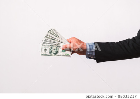 Businessman in suit holding several 100 dollar bills. Finance concept. Businessman in suit holding several 100 dollar bills. Finance concept. 88033217
