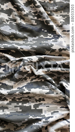 Fabric with texture of Ukrainian military pixeled camouflage. Cloth with camo pattern in grey, brown and green pixel shapes. Official uniform of Ukrainian soldiers Fabric with texture of Ukrainian military pixeled camouflage. Cloth with camo pattern in grey, brown and green pixel shapes. Official uniform of Ukrainian soldiers 88033303