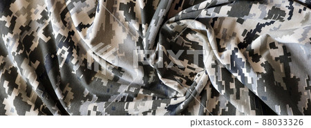 Fabric with texture of Ukrainian military pixeled camouflage. Cloth with camo pattern in grey, brown and green pixel shapes. Official uniform of Ukrainian soldiers Fabric with texture of Ukrainian military pixeled camouflage. Cloth with camo pattern in grey, brown and green pixel shapes. Official uniform of Ukrainian soldiers 88033326