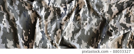 Fabric with texture of Ukrainian military pixeled camouflage. Cloth with camo pattern in grey, brown and green pixel shapes. Official uniform of Ukrainian soldiers Fabric with texture of Ukrainian military pixeled camouflage. Cloth with camo pattern in grey, brown and green pixel shapes. Official uniform of Ukrainian soldiers 88033327