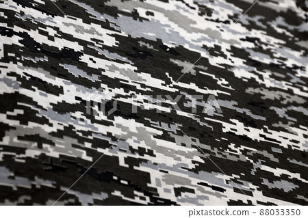 Fabric with texture of Ukrainian military pixeled camouflage. Cloth with camo pattern in grey, brown and green pixel shapes. Official uniform of Ukrainian soldiers Fabric with texture of Ukrainian military pixeled camouflage. Cloth with camo pattern in grey, brown and green pixel shapes. Official uniform of Ukrainian soldiers 88033350