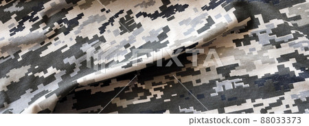 Fabric with texture of Ukrainian military pixeled camouflage. Cloth with camo pattern in grey, brown and green pixel shapes. Official uniform of Ukrainian soldiers Fabric with texture of Ukrainian military pixeled camouflage. Cloth with camo pattern in grey, brown and green pixel shapes. Official uniform of Ukrainian soldiers 88033373