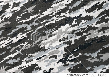 Fabric with texture of Ukrainian military pixeled camouflage. Cloth with camo pattern in grey, brown and green pixel shapes. Official uniform of Ukrainian soldiers 88033385