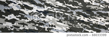 Fabric with texture of Ukrainian military pixeled camouflage. Cloth with camo pattern in grey, brown and green pixel shapes. Official uniform of Ukrainian soldiers Fabric with texture of Ukrainian military pixeled camouflage. Cloth with camo pattern in grey, brown and green pixel shapes. Official uniform of Ukrainian soldiers 88033399