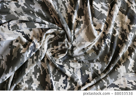 Fabric with texture of Ukrainian military pixeled camouflage. Cloth with camo pattern in grey, brown and green pixel shapes. Official uniform of Ukrainian soldiers 88033538