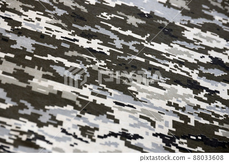 Fabric with texture of Ukrainian military pixeled camouflage. Cloth with camo pattern in grey, brown and green pixel shapes. Official uniform of Ukrainian soldiers 88033608