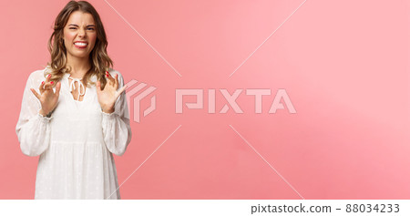 Portrait of girl cringe as telling friend disgusting awful story of her date with guy, show tongue grimacing and press hands to body as feeling discomfort and aversion, stand pink background 88034233