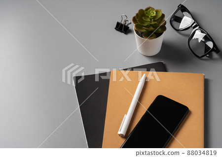 Office desk with notepad, glasses and supplies Office desk with notepad, glasses and supplies 88034819