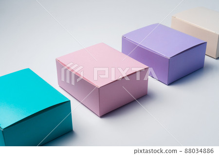 Pile of colorful cardboard boxes on white background Pile of colorful cardboard boxes on white background 88034886
