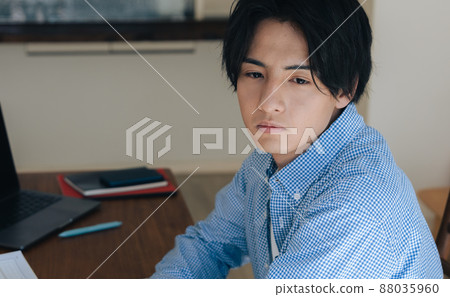 A young man studying at home A young man studying at home 88035960