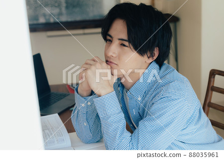A young man studying at home A young man studying at home 88035961