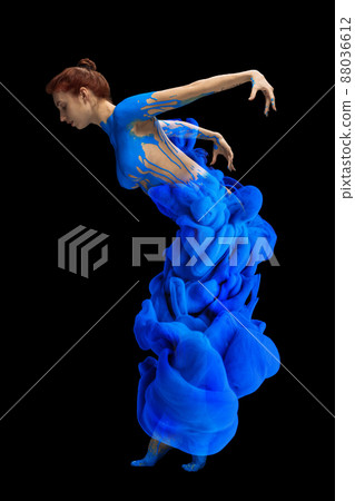 Portrait of young beautiful woman covered with black thick pain and dye splash dancing isolated over black background. Flexibility Portrait of young beautiful woman covered with black thick pain and dye splash dancing isolated over black background. Flexibility 88036612