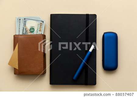 Iqos electronic blue cigarette on a beige background. Iqos electronic blue cigarette on a beige background. 88037407