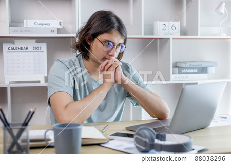 Young Asian men are greeting friends and teachers through video chats and greeting them with cheerful expressions, Online communication , Stay home, New normal, VDO Call, Social distancing, Internet l 88038296