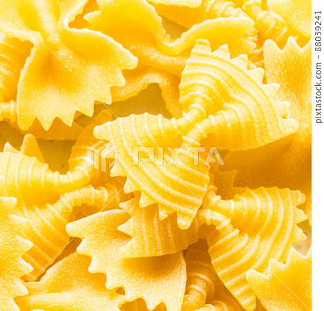 background from uncooked farfalle pasta pieces 88039241
