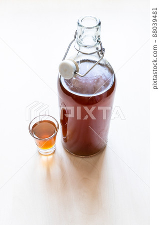 shot and bottle of homemade alcoholic tincture 88039481
