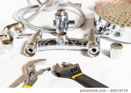 wrenches closeup and disassembled shower faucet wrenches closeup and disassembled shower faucet 88039739