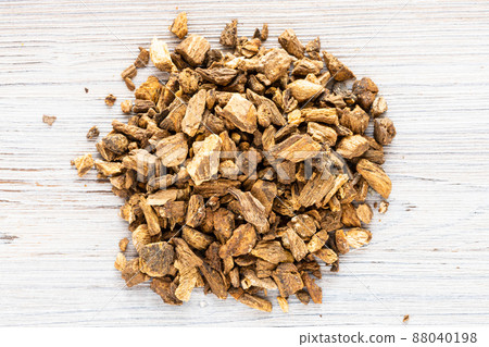 pile of dried burdock roots on gray wooden board pile of dried burdock roots on gray wooden board 88040198