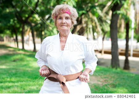 Old woman in kimono training in park Old woman in kimono training in park 88042401