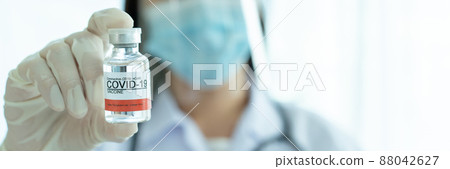 Doctor showing a COVID-19 or coronavirus vaccine on hand close up with copyspace. COVID-19 cure vaccine for injection use only. Doctor preparing a COVID 19 vaccine for injection to patient. 88042627