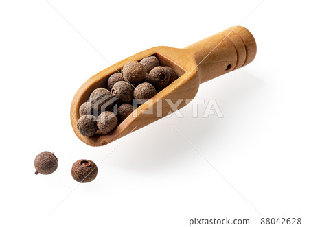 Allspice jamaica pepper in a small wooden scoop cutout. 88042628