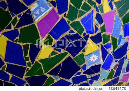 Wall decoration with ceramic mosaics of bright colors and unequal sizes. Wall decoration with ceramic mosaics of bright colors and unequal sizes. 88043278