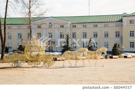 Outdoor sculpture of a horse with a carriage on a frame of light bulbs. Outdoor sculpture of a horse with a carriage on a frame of light bulbs. 88044557