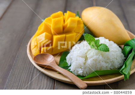 Coconut Flavored Sticky Rice with Ripe Mango on wood dish, .Popular Thai desserts 88044859