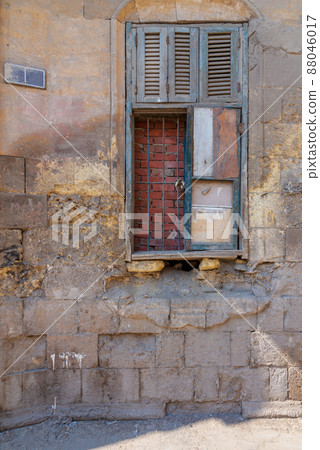 Broken windows and grunge stone bricks wall in abandoned district 88046017