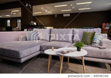 Furniture store showroom interior. Focus on the beautiful modern gray sofa and coffee table. An exhibition of couches and sofas in a modern luxury furniture store. Furniture store showroom interior. Focus on the beautiful modern gray sofa and coffee table. An exhibition of couches and sofas in a modern luxury furniture store. 88046168