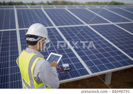 Electrical engineering works with solar panels to produce renewable energy. 88046791