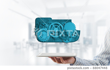 Close of businessman holding tablet pc with engine presenting teamwork and cooperation Close of businessman holding tablet pc with engine presenting teamwork and cooperation 88047448