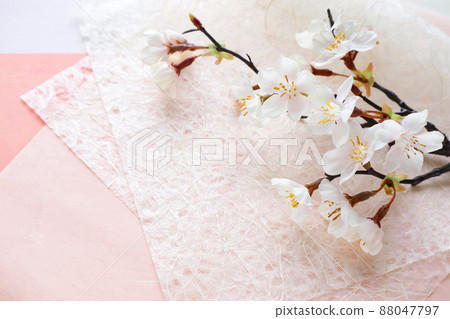 Cherry blossom branches on a pink Japanese paper background Cherry blossom branches on a pink Japanese paper background 88047797