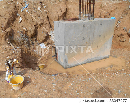 SELANGOR, MALAYSIA -JULY 4, 2021: The concrete pile cap and column stump are under construction at the construction site. Both are part of the building's foundation system. SELANGOR, MALAYSIA -JULY 4, 2021: The concrete pile cap and column stump are under construction at the construction site. Both are part of the building's foundation system. 88047977