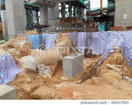 SELANGOR, MALAYSIA -JULY 4, 2021: The concrete pile cap and column stump are under construction at the construction site. Both are part of the building's foundation system. 88047985