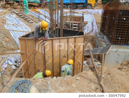 SELANGOR, MALAYSIA -JULY 4, 2021: The concrete pile cap and column stump are under construction at the construction site. Both are part of the building's foundation system. SELANGOR, MALAYSIA -JULY 4, 2021: The concrete pile cap and column stump are under construction at the construction site. Both are part of the building's foundation system. 88047992